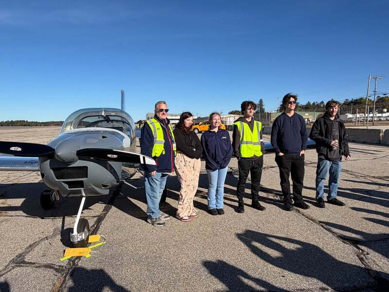 MHT students, instructor Jeff Sullivan in front of completed MST plane