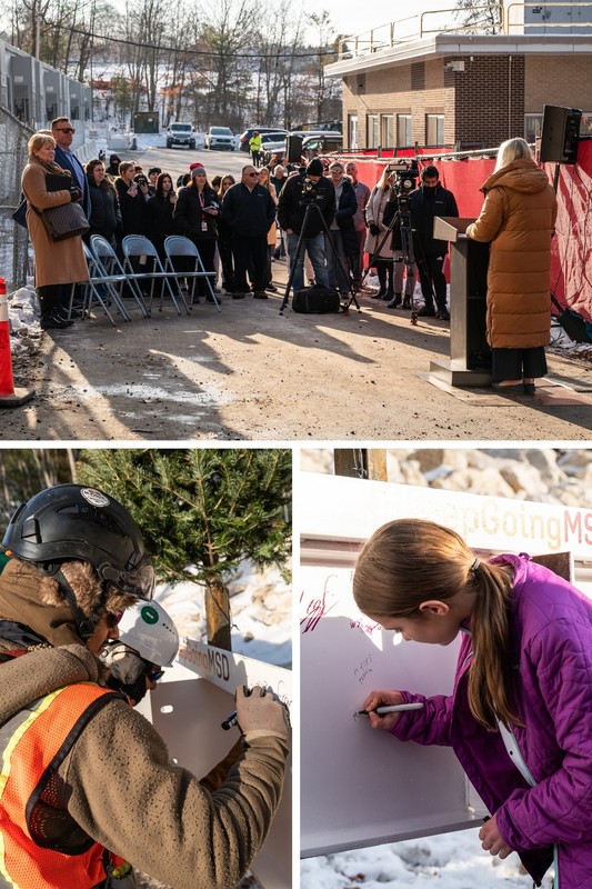 Students district and construction crews sign beam at hillside