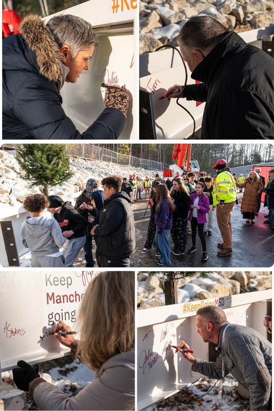 Students district and construction crews sign beam at hillside