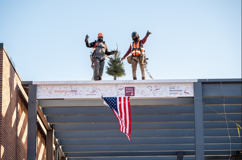 beam being raised into place at mclaughlin beam raising ceremony