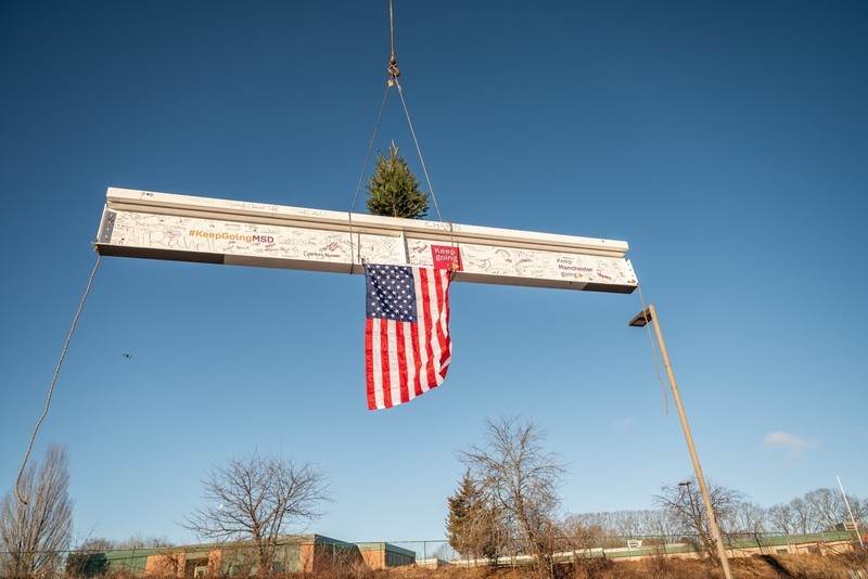 beam being raised into place at mclaughlin beam raising ceremony