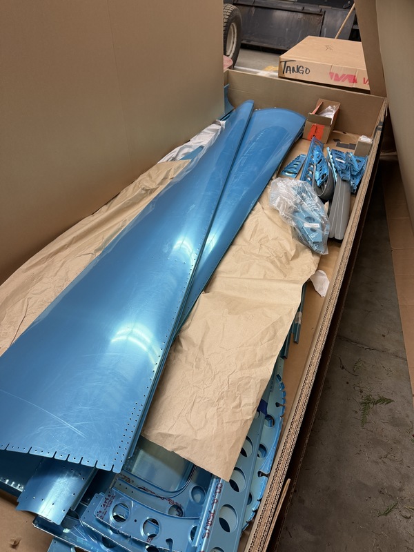 Unassembled plane pieces in delivery boxes at MST