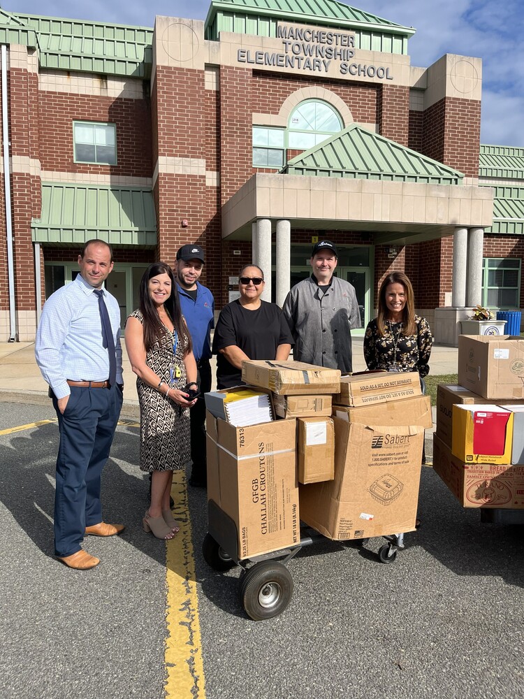 A delivery of school supplies in front of MTES