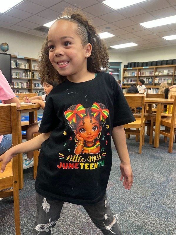 A student shows her Juneteenth shirt!