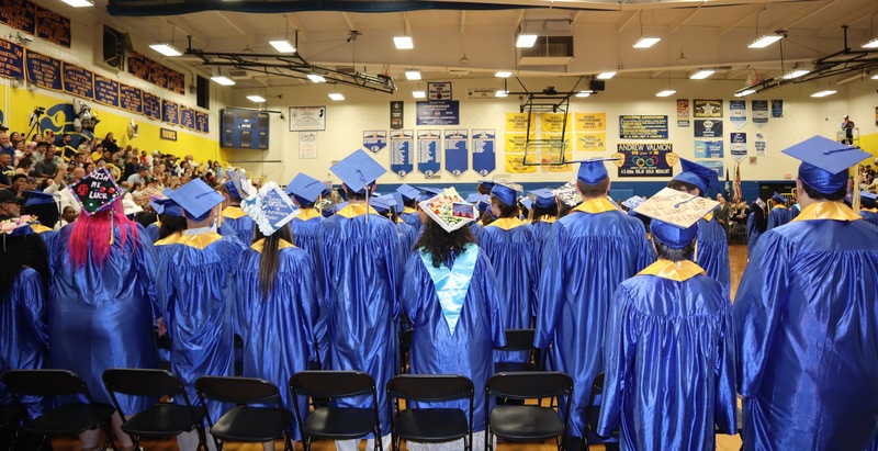 Graduates stand