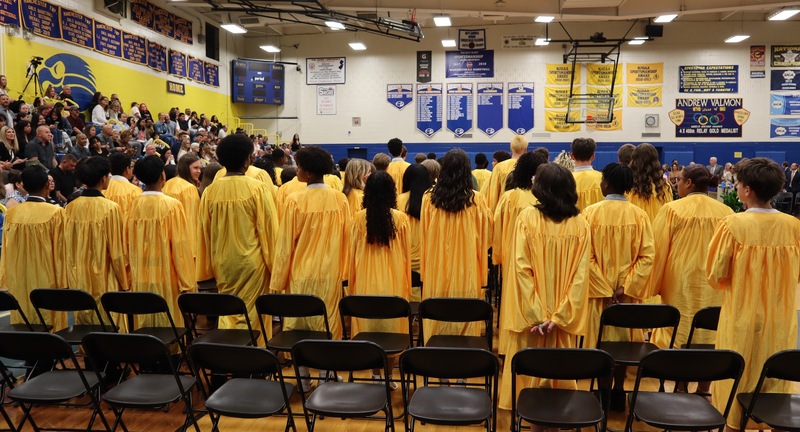 Graduates stand