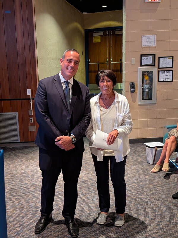 Cathy accepting a recognition certificate