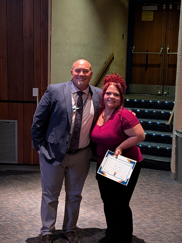 Ada accepting a recognition certificate