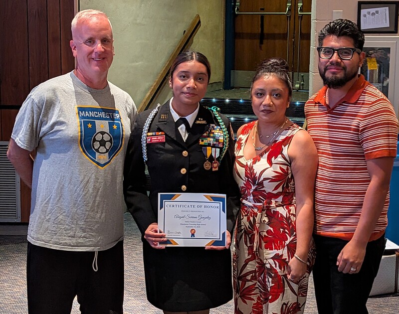 Abigail accepting a recognition certificate