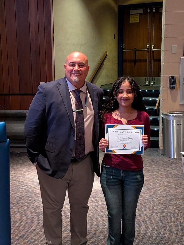 Angela accepting a recognition certificate