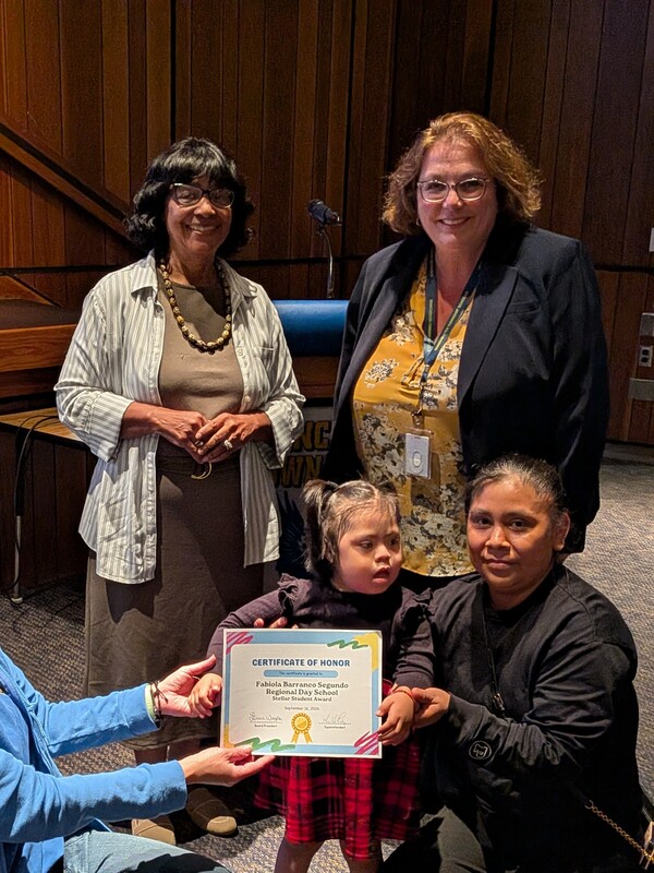 Fabiola receiving recognition certificate