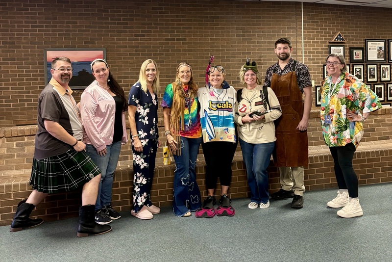 Staff members wearing atypical outfits for Tuesday's theme