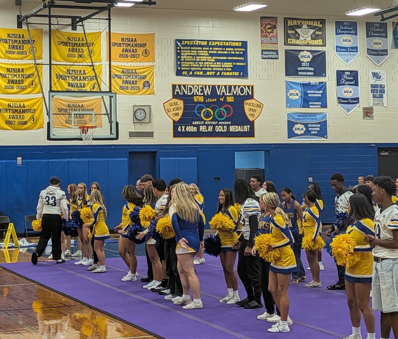 Hawk cheerleaders & football team members at the pep rally