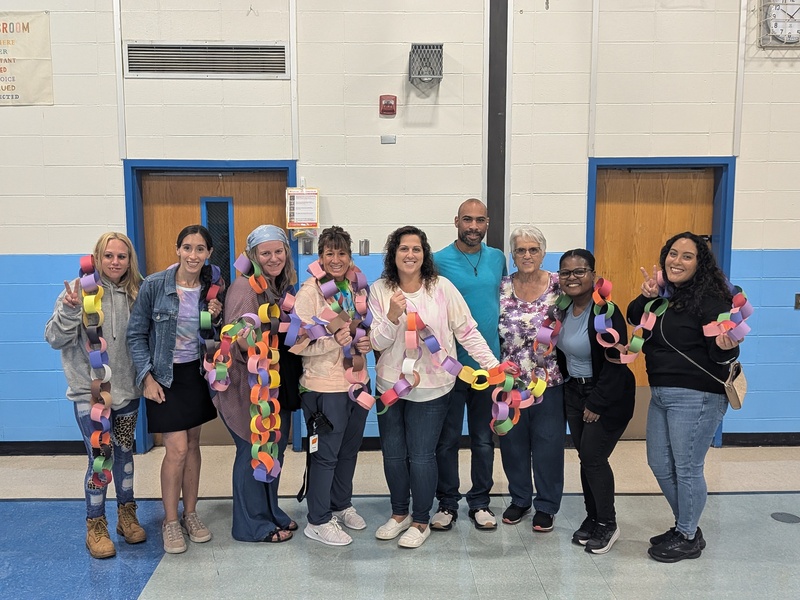 Helpers hold up the completed Friendship Chain