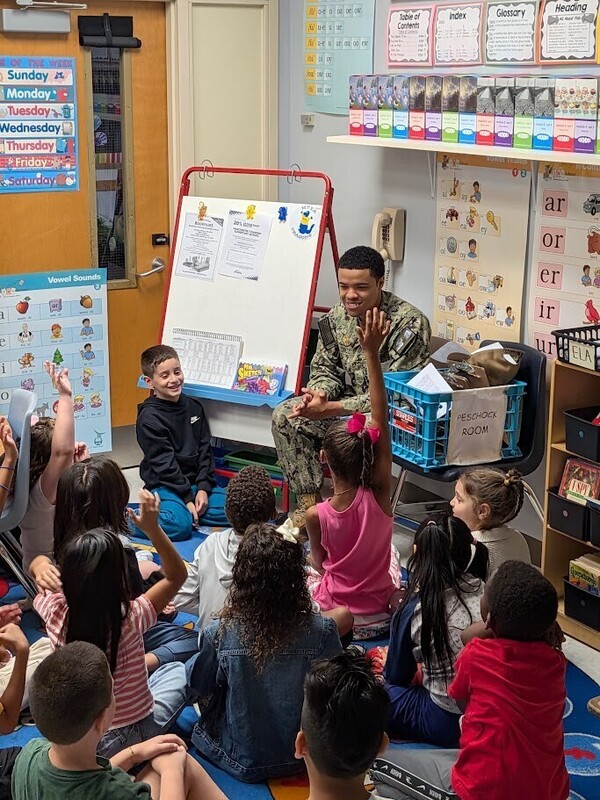 A JB-MDL Reading Buddy answers questions from students at MTES