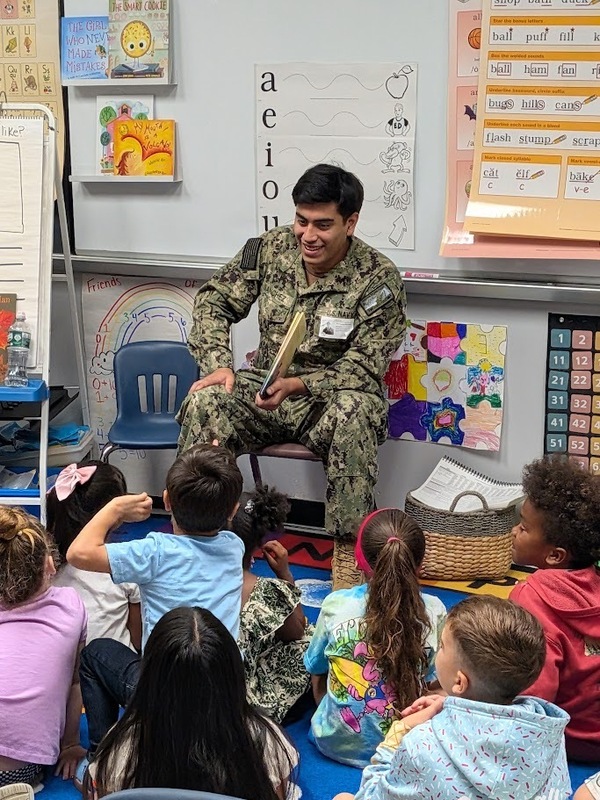 A JB-MDL Reading Buddy answers questions from students at MTES