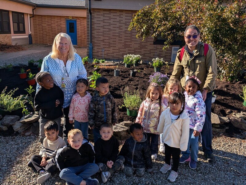 Students posing for a photo in the courtyard garden