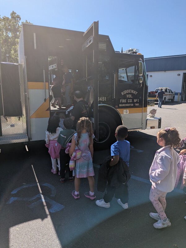 MTES students step into the cabin of a firetruck