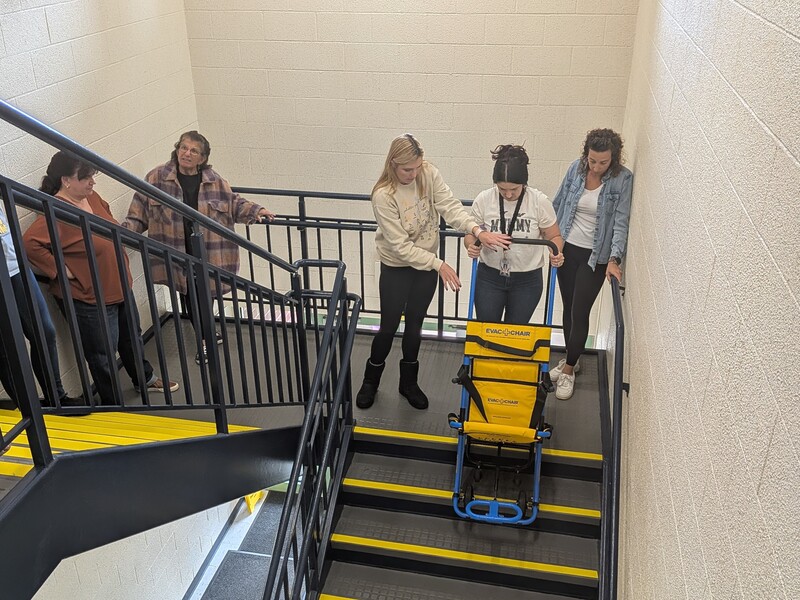 MTES staff practice using an emergency evacuation chair