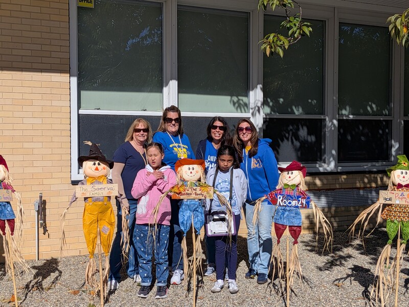 WES students posing with the scarecrows
