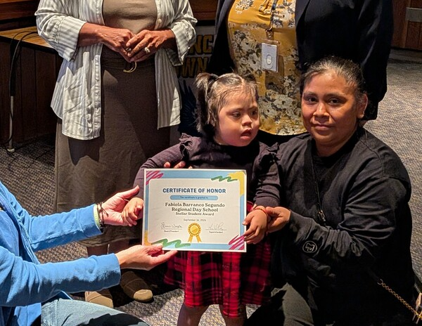 Fabiola receiving recognition certificate