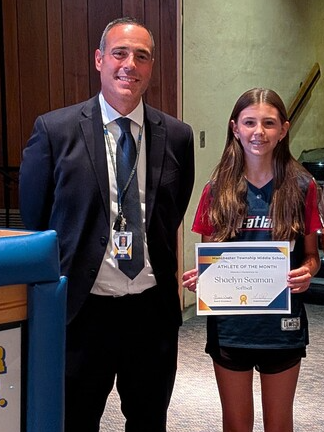Shaelyn accepting a recognition certificate