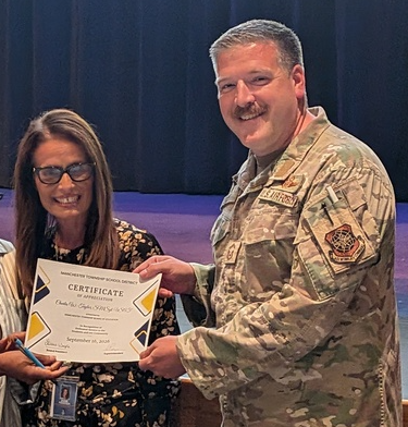 MSgt Taylor accepting certificate of recognition