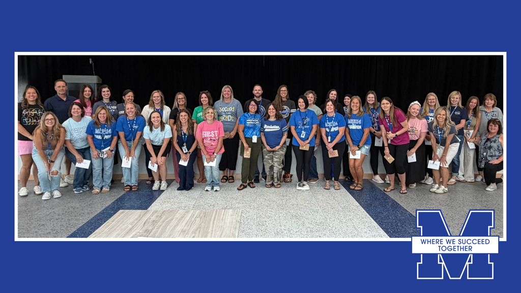 Group of people in blue shirts standing in a row for a photo, with a blue background.