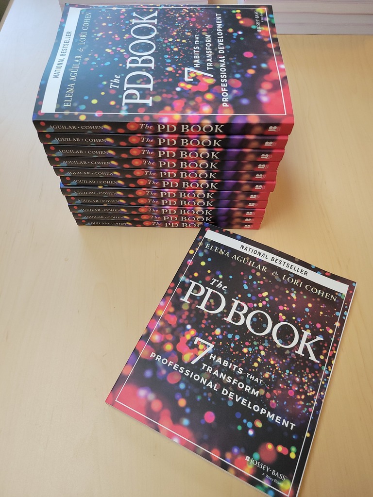 Stack of copies of The PD Book by Elena Aguilar