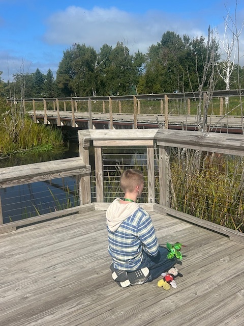Student sitting on a docl