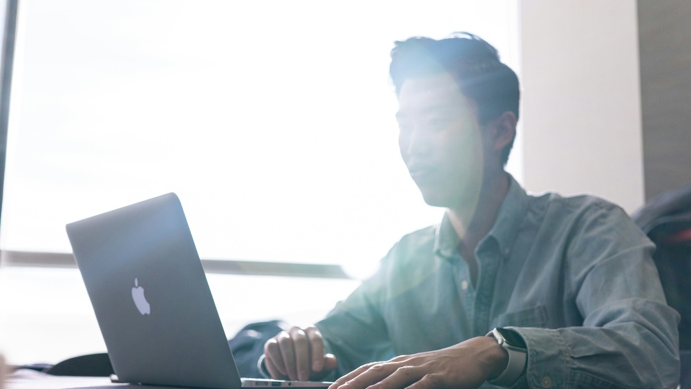 Student sits at a computer.