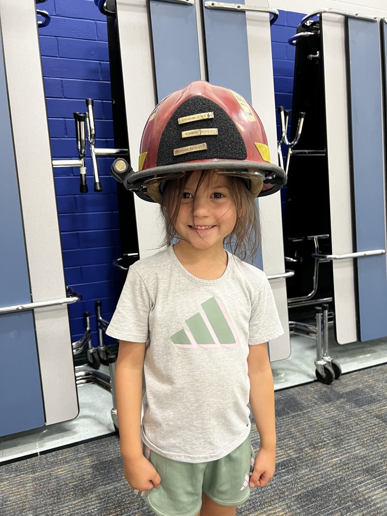Student in fire fighter helmet.