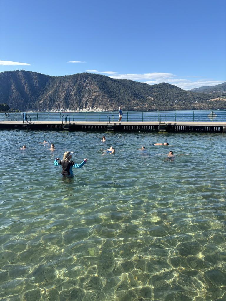 Students doing back floats in the lake.