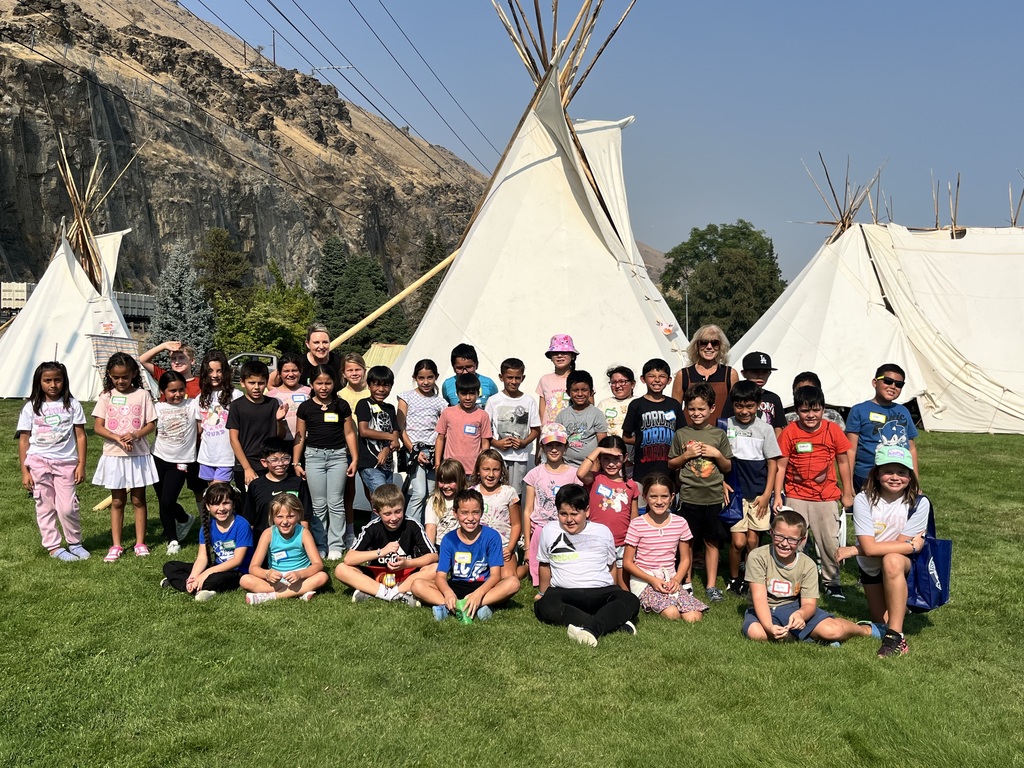 Student in front of teepees
