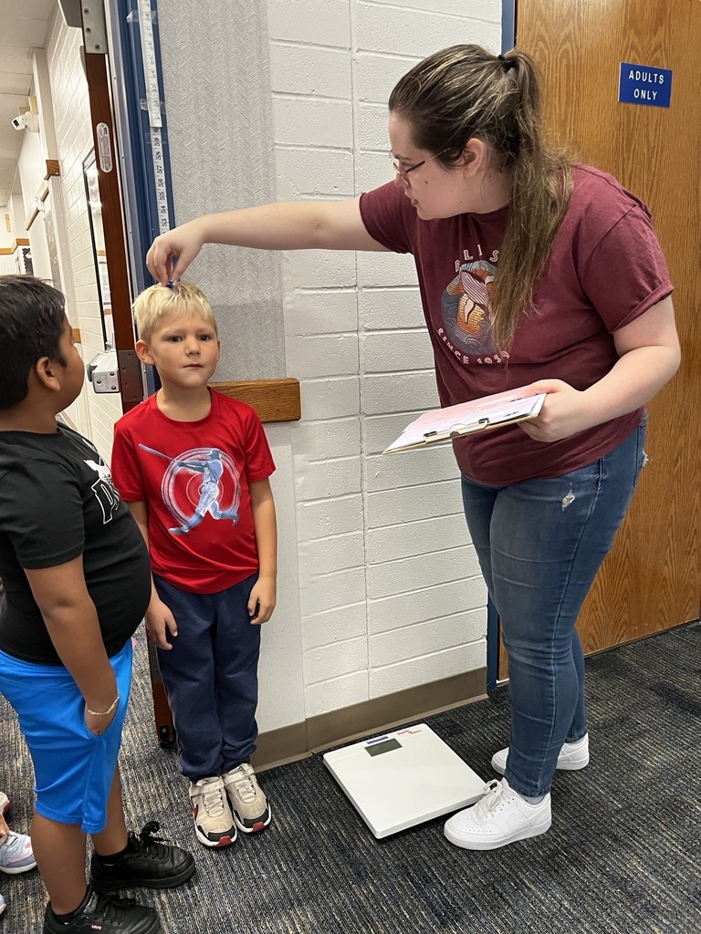 Boy getting measured.