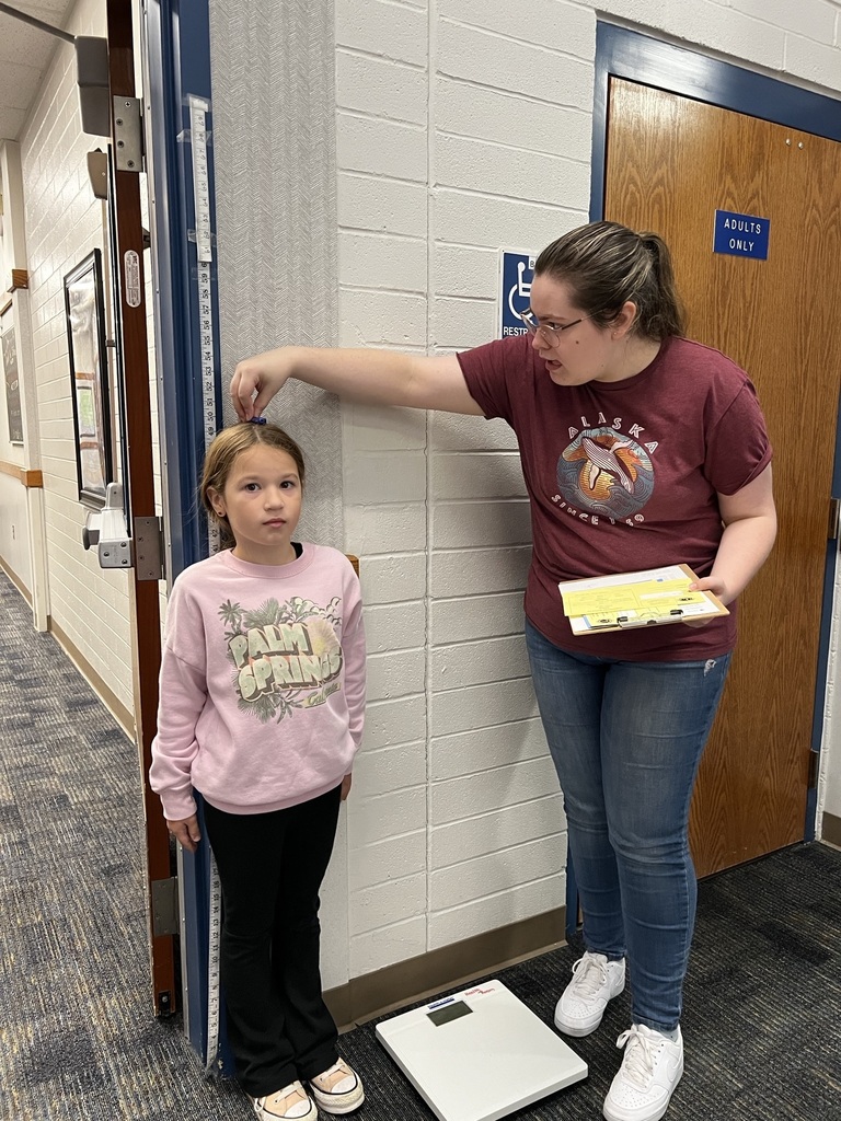 Girl getting measured.