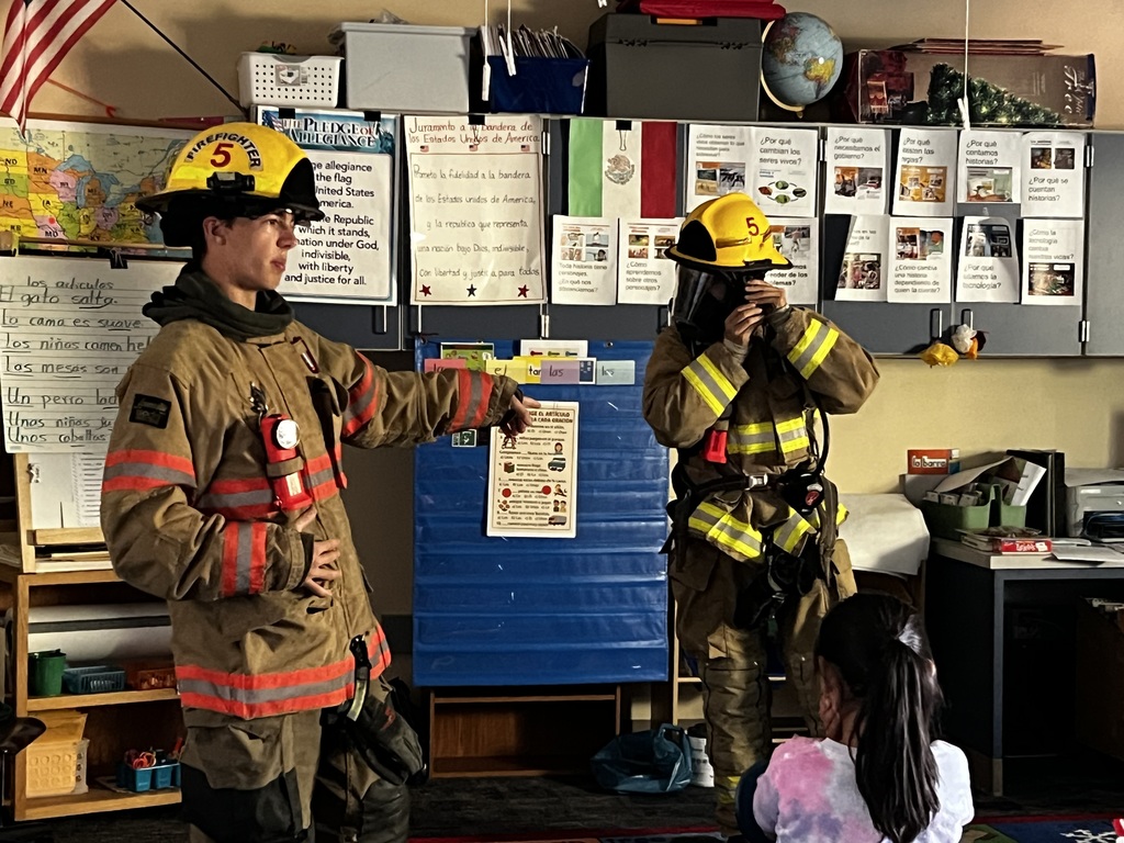 Jr. firefighters trying on gear.