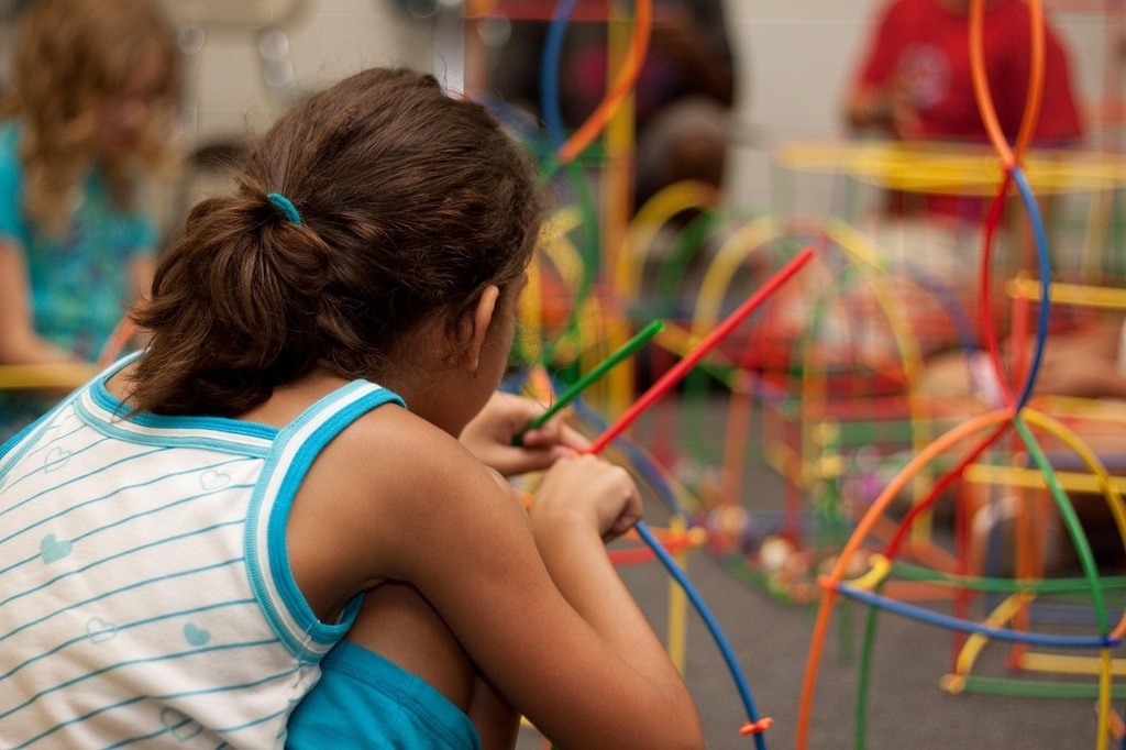 Girl building with bendable rods.