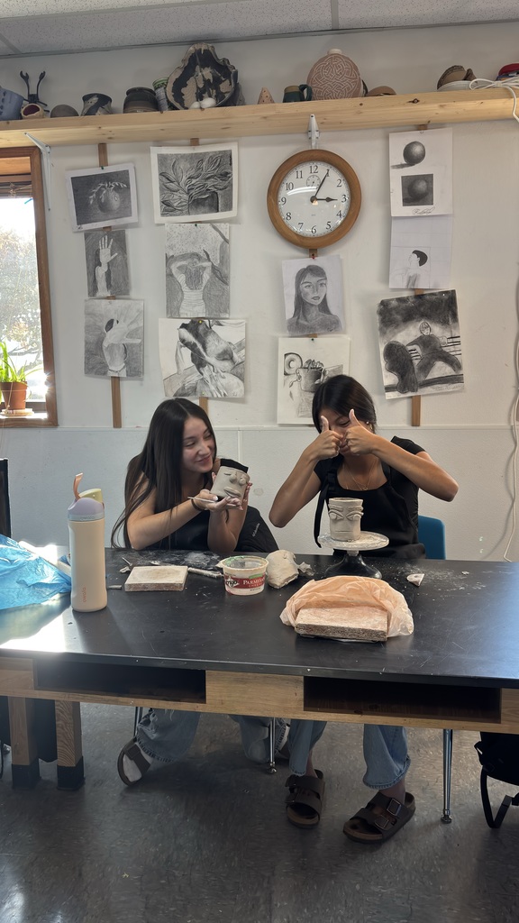 Art students working on pottery.