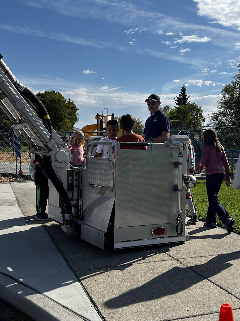 Lt Baker in the Ladder Truck Bucket with Students.