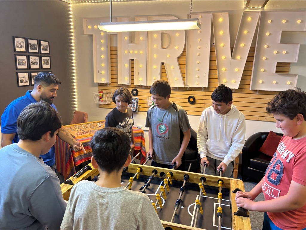 Boys playing foosball.