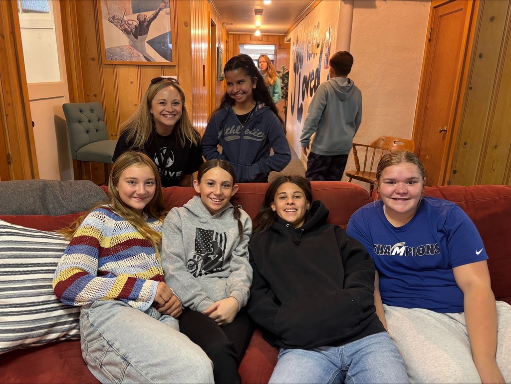 Middle School girls sitting on sofa.