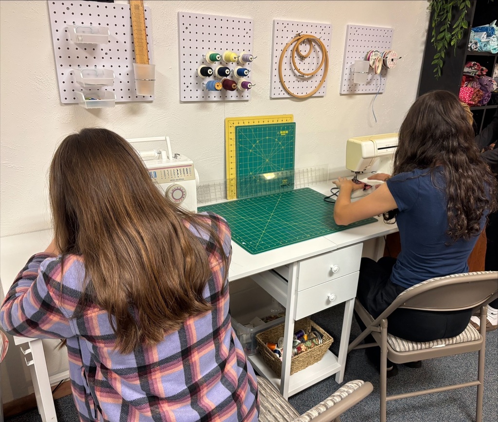 Middle School girls sewing.