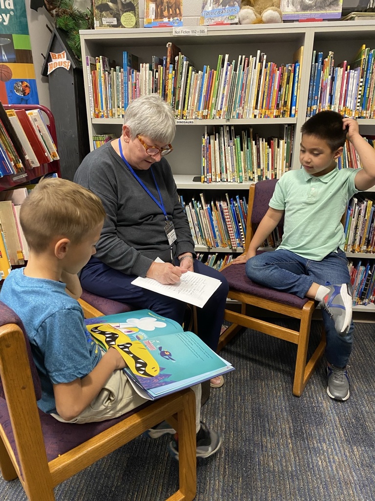 Three Reading Buddies in the hallway.