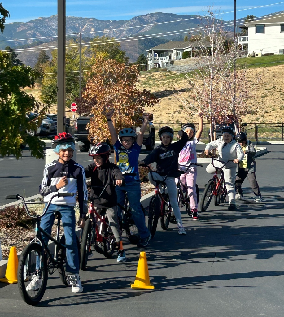 Elementary students on bikes practicing safety.