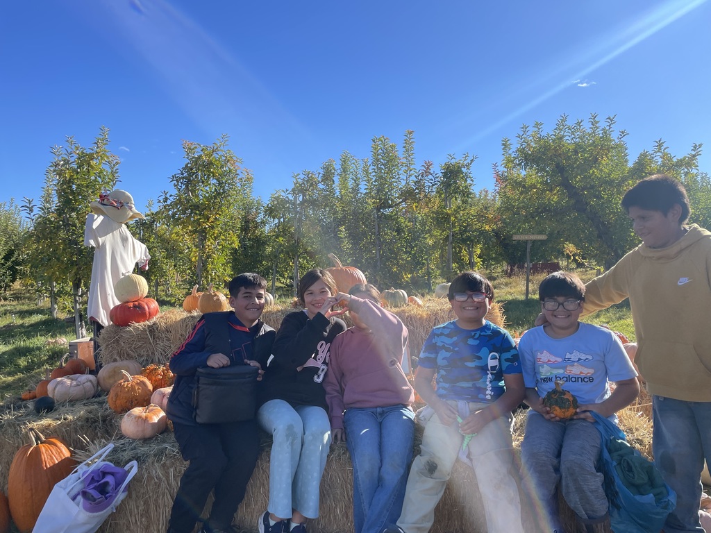 Students sit on hay bales at Chelan Valley Farm.