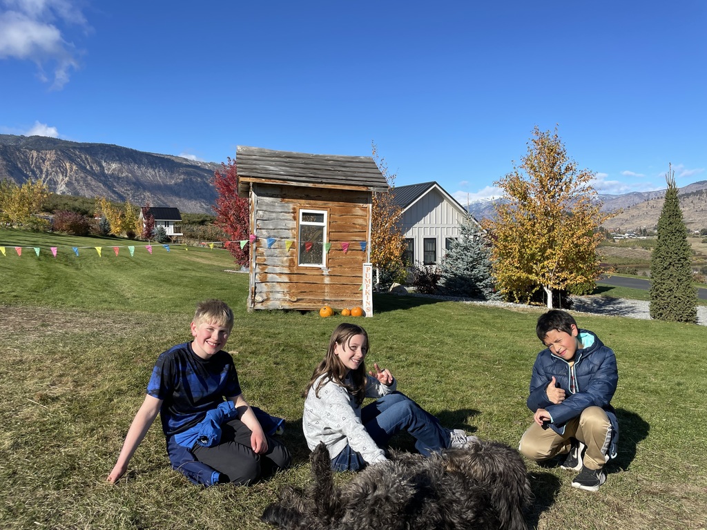 Students petting a farm dog.