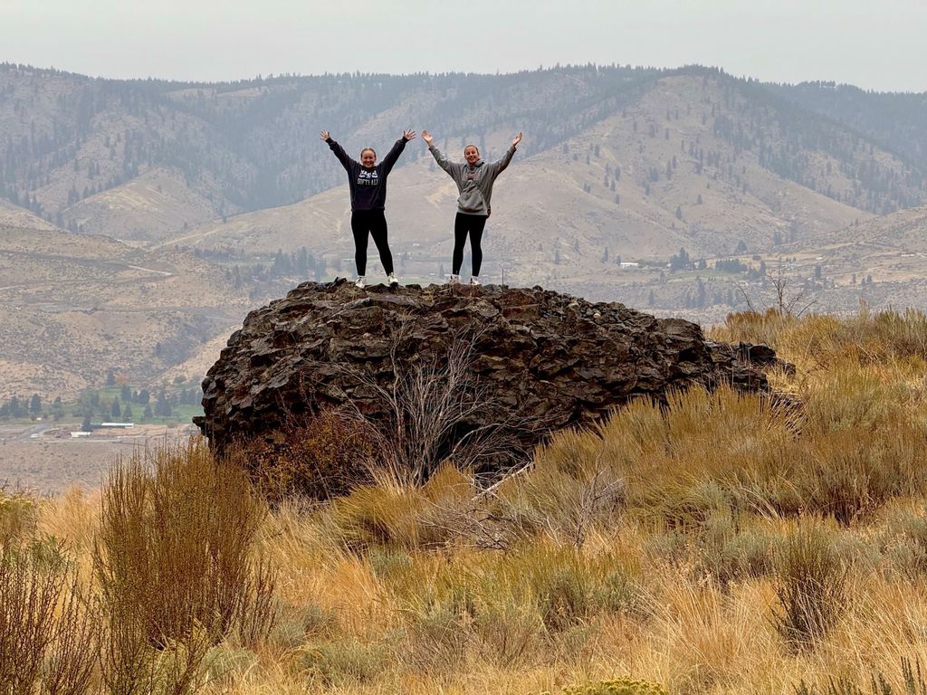 Two girls pose on a rock on the hike to Elephant Head.