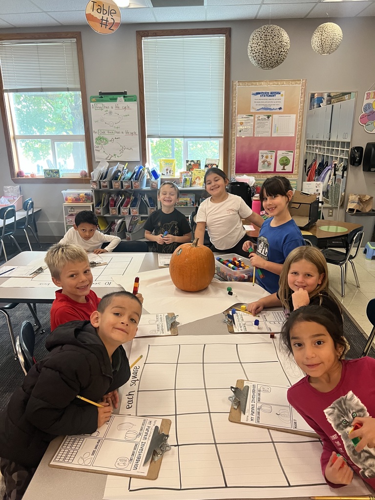 A table full of students ready to study pumpkins.