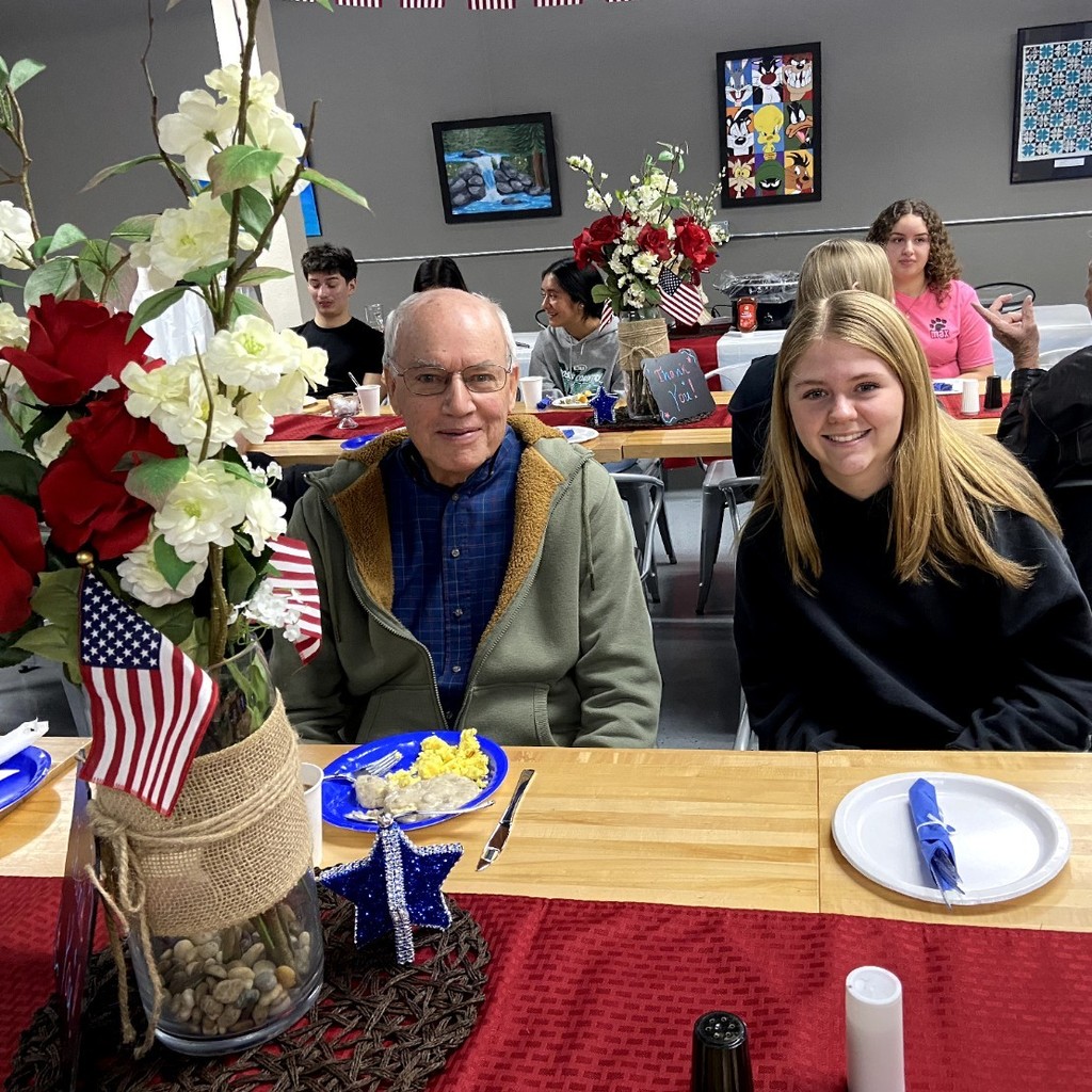 Veteran and student enjoy breakfast.